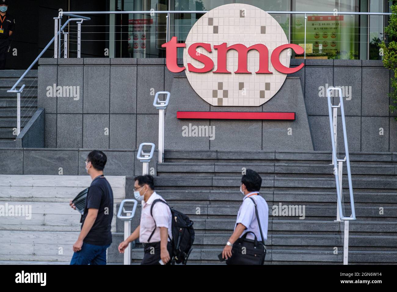 Hsinchu, Taiwan. 22nd Sep, 2021. People walk past a TSMC (Taiwan