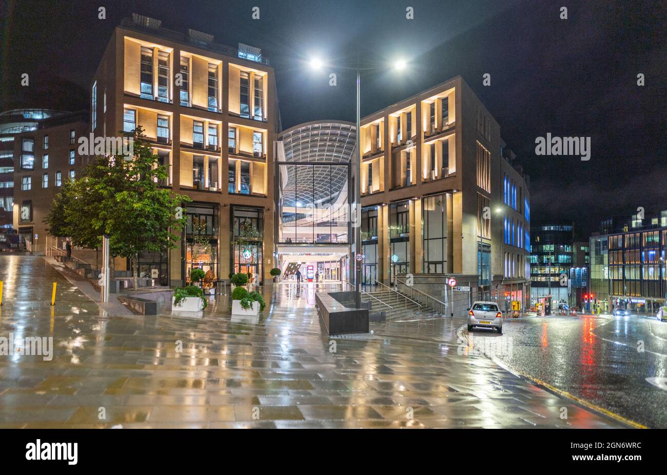 Exterior view at night of new St James Quarter shopping and