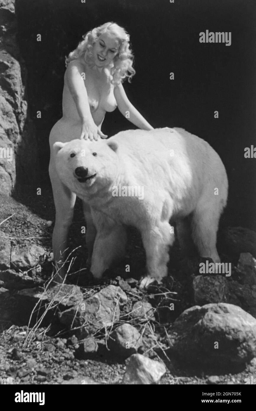 1940s / 1950s nude glamour model with polar bear Stock Photo