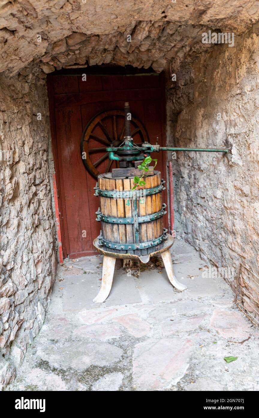 ancient press for crushing grapes for the production of wine Stock Photo