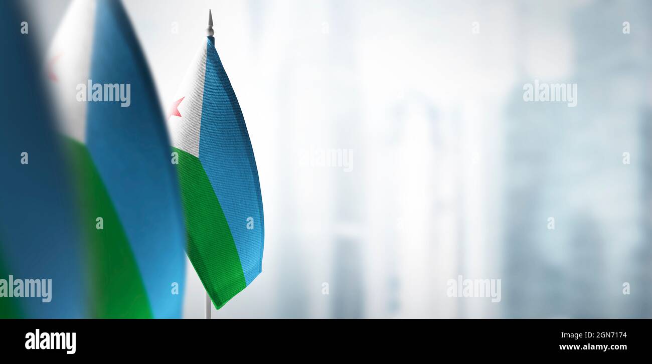 Small flags of Djibouti on a blurry background of the city Stock Photo