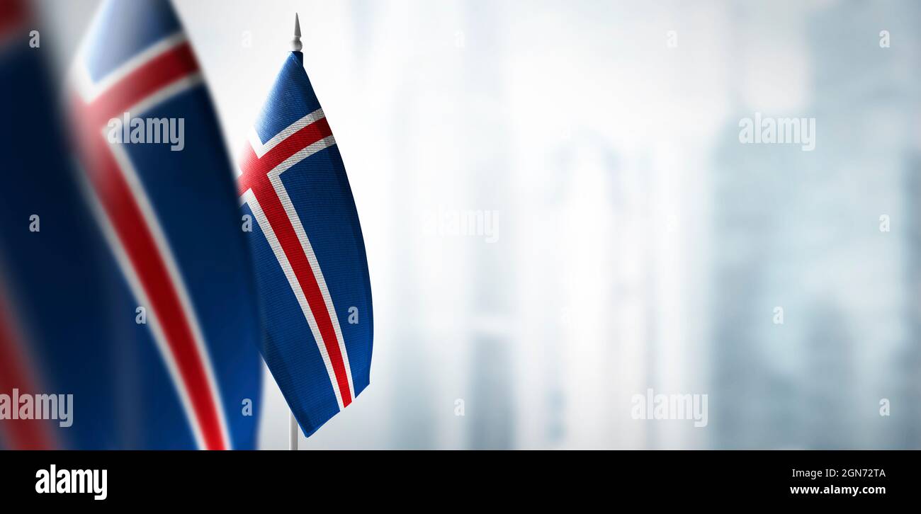 Small flags of Iceland on a blurry background of the city Stock Photo