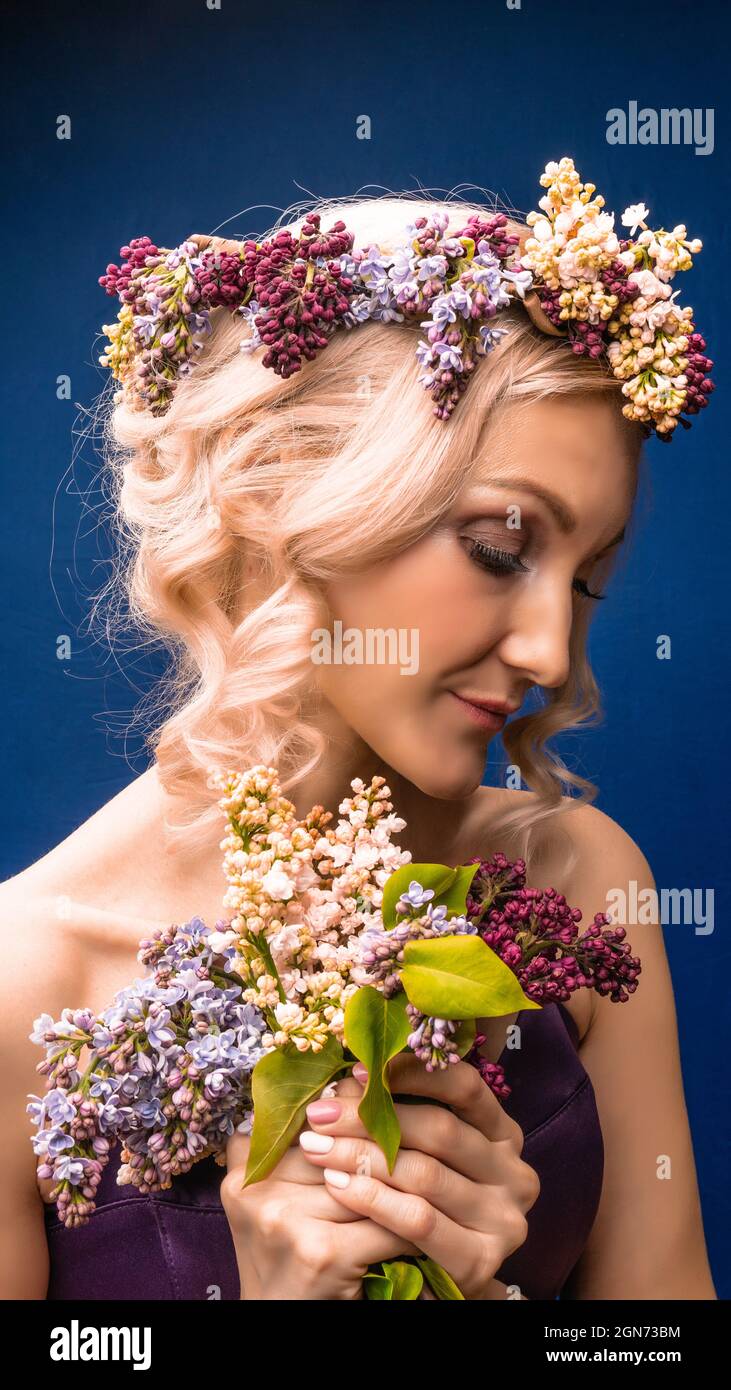 A safe green wonderful in a lilac wreath with a charismatic appearance rejoices blue background, with a day Stock Photo