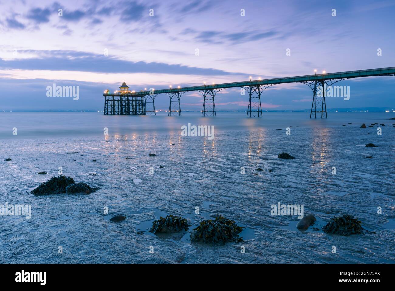 Clevedon Pier in the Severn Estuary at low tide after sunset, North Somerset, England. Stock Photo