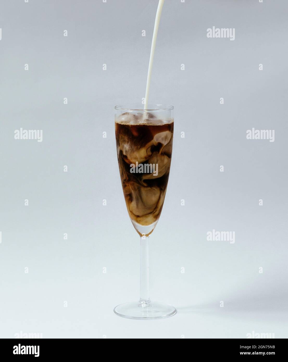 https://c8.alamy.com/comp/2GN75NB/milk-pouring-into-iced-coffee-swirling-on-white-background-2GN75NB.jpg