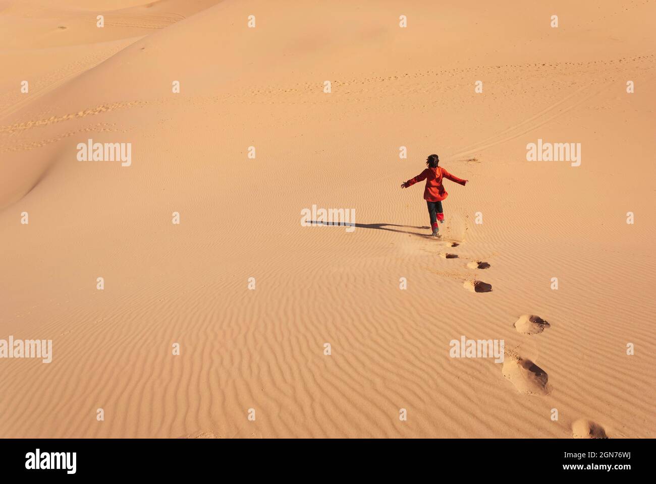 woman running happily down a desert dune Stock Photo - Alamy