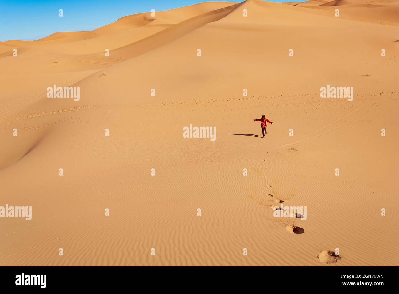woman running happily down a desert dune Stock Photo - Alamy