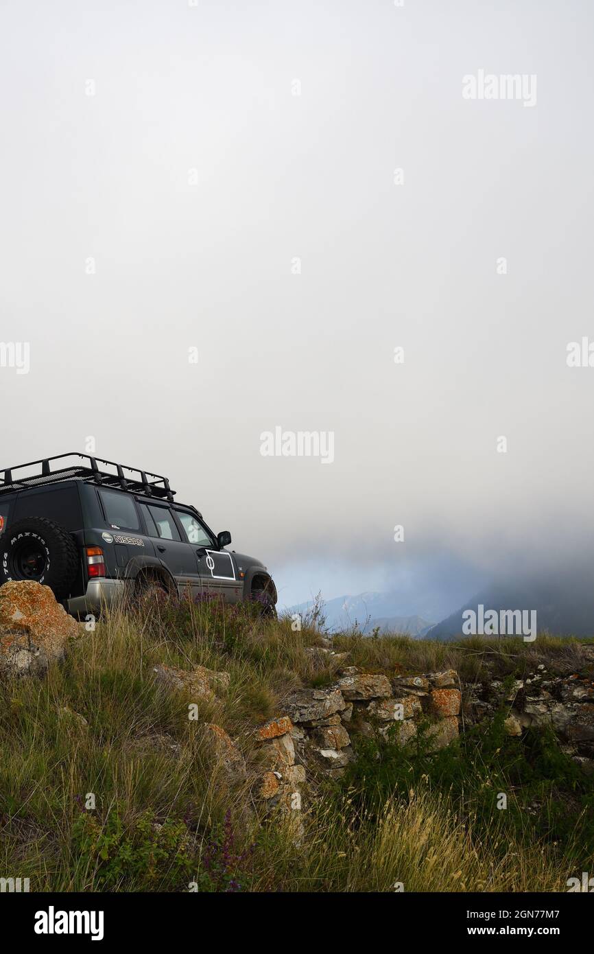 Chechnya, Russia - Sept 12, 2021: Off-road car shown in the Caucasus mountains. Vedeno district of the Chechen Republic. Extreme mountain safari is on Stock Photo