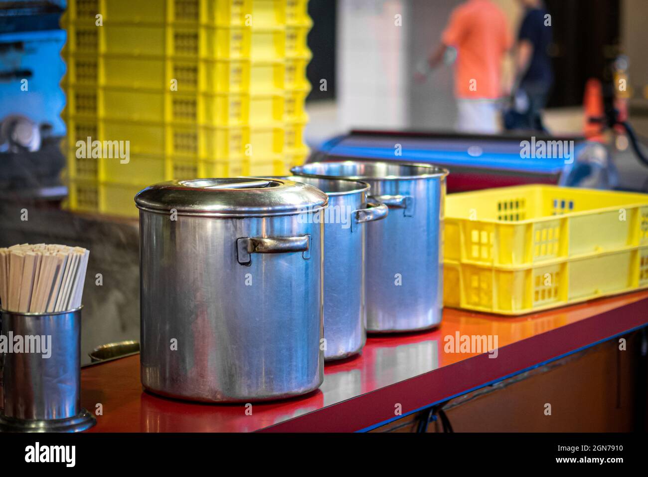 Metal pans on the wooden table in Japanese street cafe Stock Photo