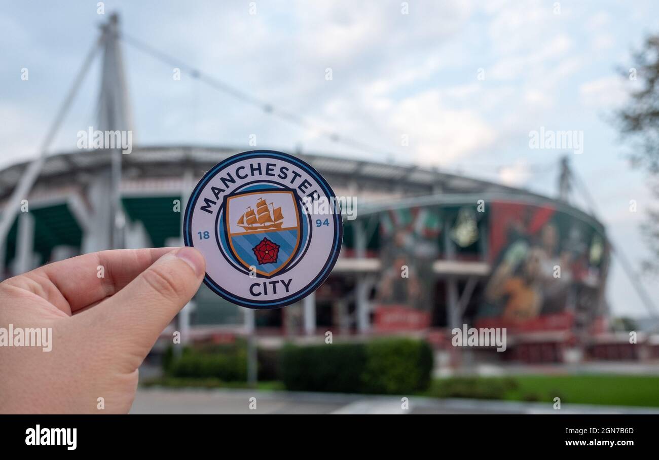 August 30, 2021 Manchester, UK. Manchester City F.C. football club emblem against the backdrop of a modern stadium. Stock Photo
