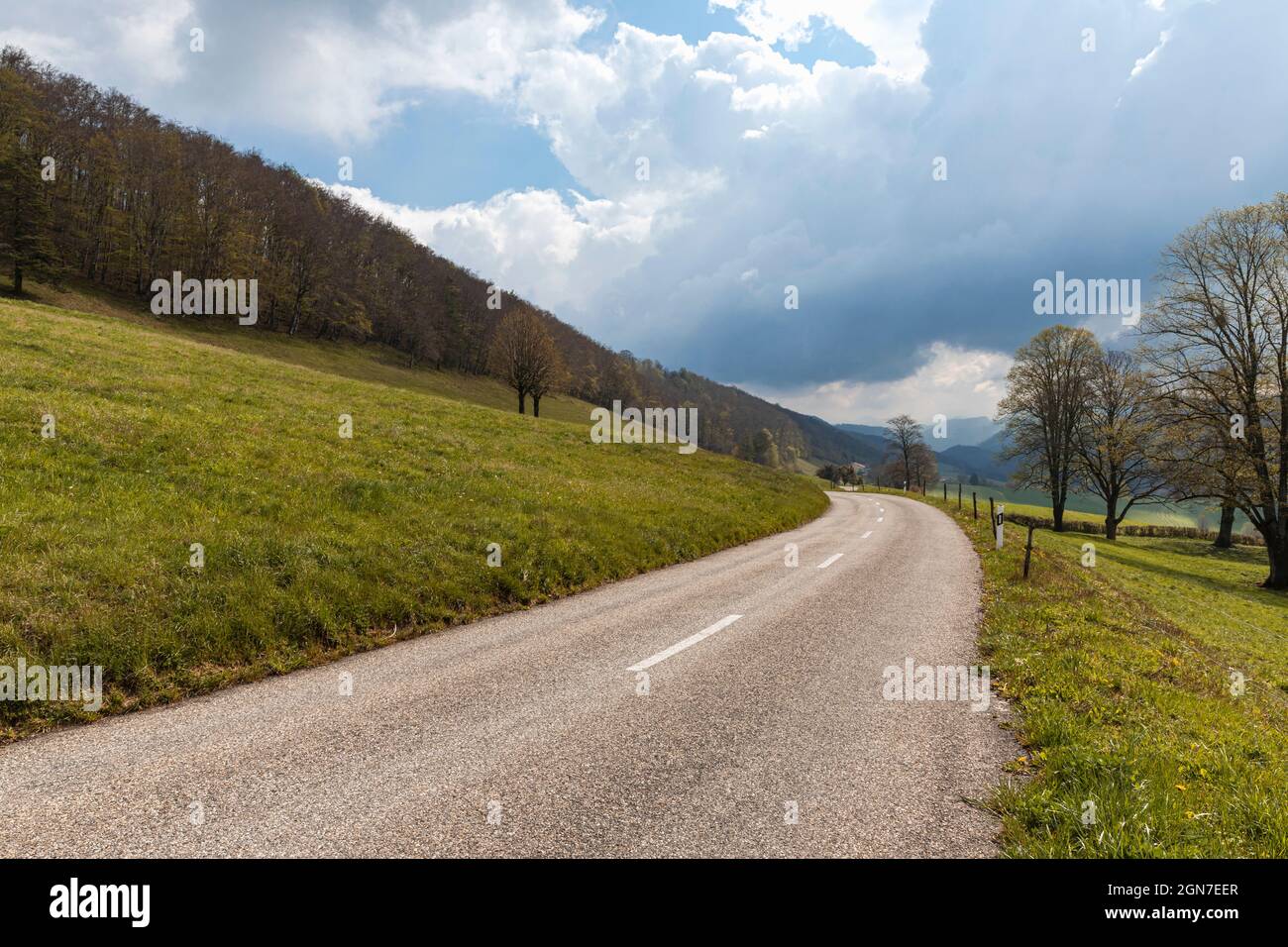 Isolated road in the Swiss Alps of the Jura Canton. Nobody inside. Cloudy day Stock Photo