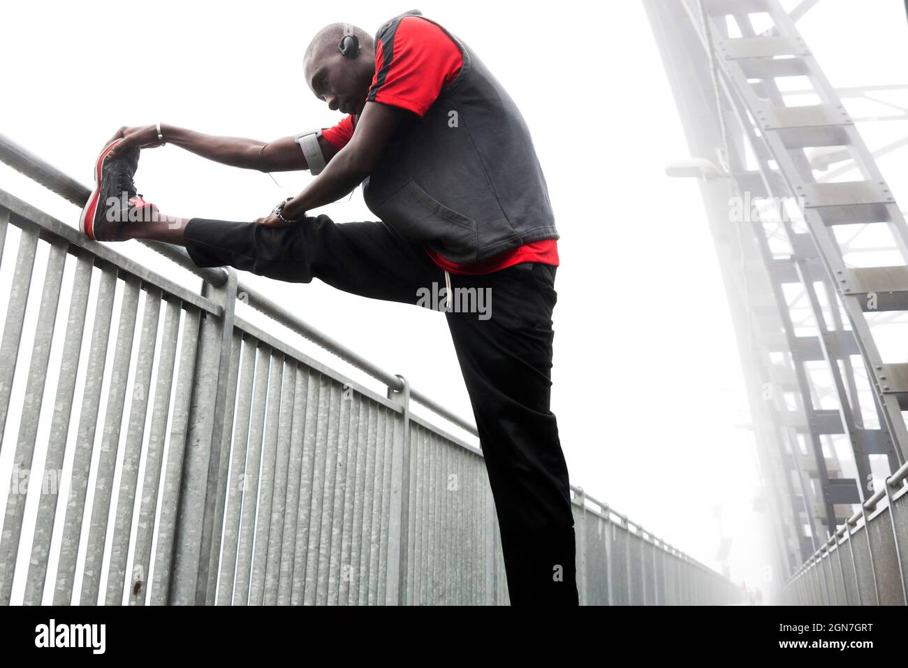 african american runner stretching muscles outdoors before the race on ...