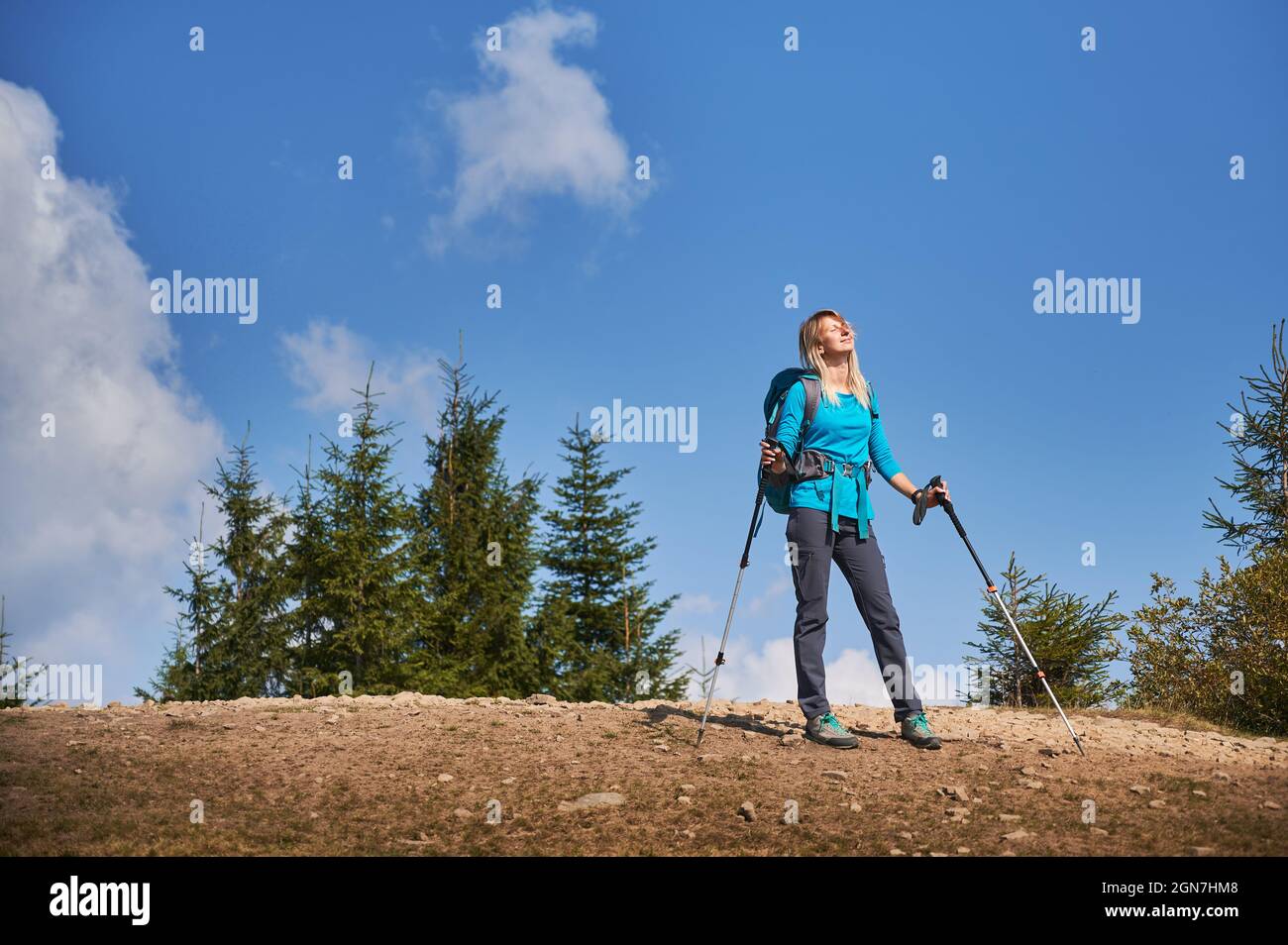 Sporty Woman Hiker with Backpack and Trekking Sticks Hiking in the  Mountains Stock Photo - Image of mountain, alone: 115108360