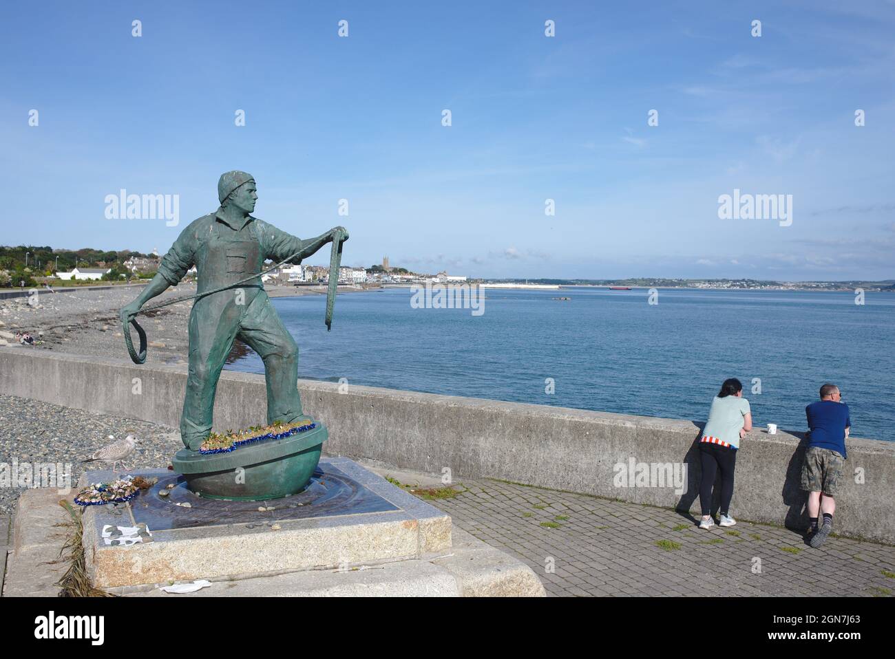 Looking out to sea. The Newlyn Fisherman Memorial sculpture  by artist Tom Leaper. Newlyn, Cornwall UK Stock Photo