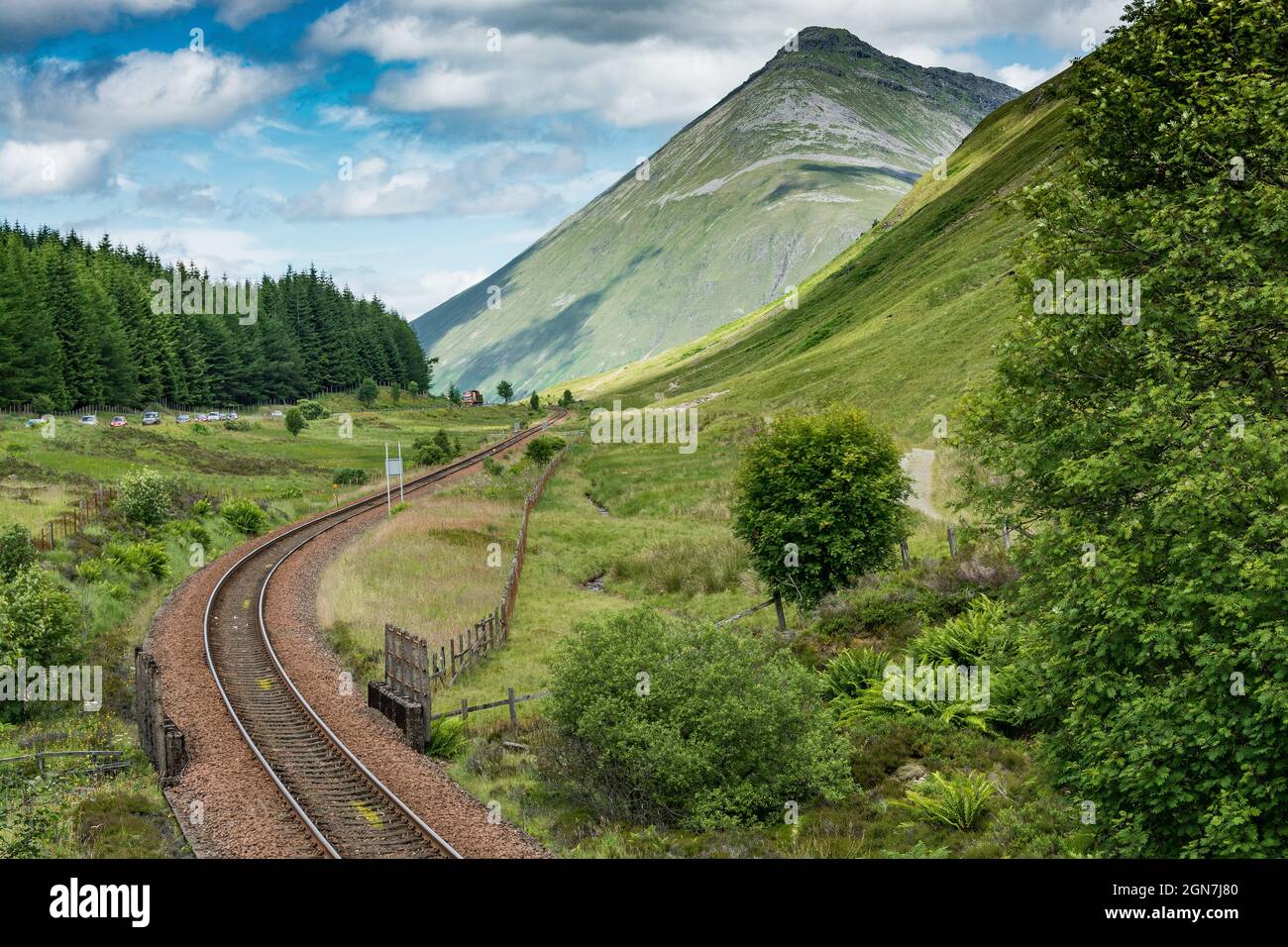 Along the West highland Way in Scotland. a view of the Milngavie - Fort William railway line and of Beinn Dorain mountain Stock Photo