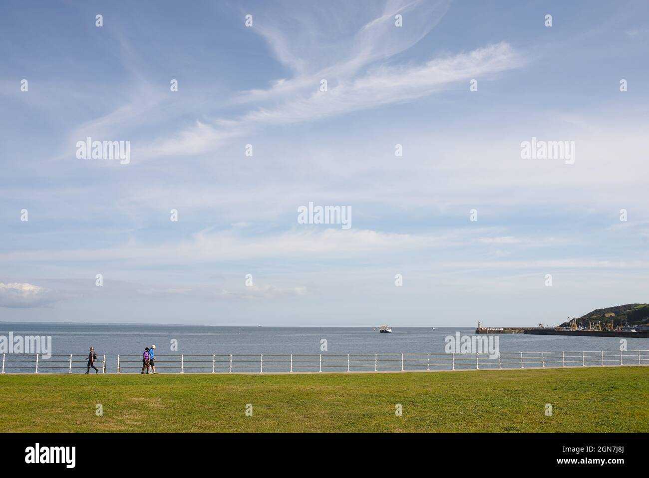 Walking along the seafront at Newlyn Green, Newlyn. A part of the South West Coast Path. Newlyn, Cornwall UK Stock Photo