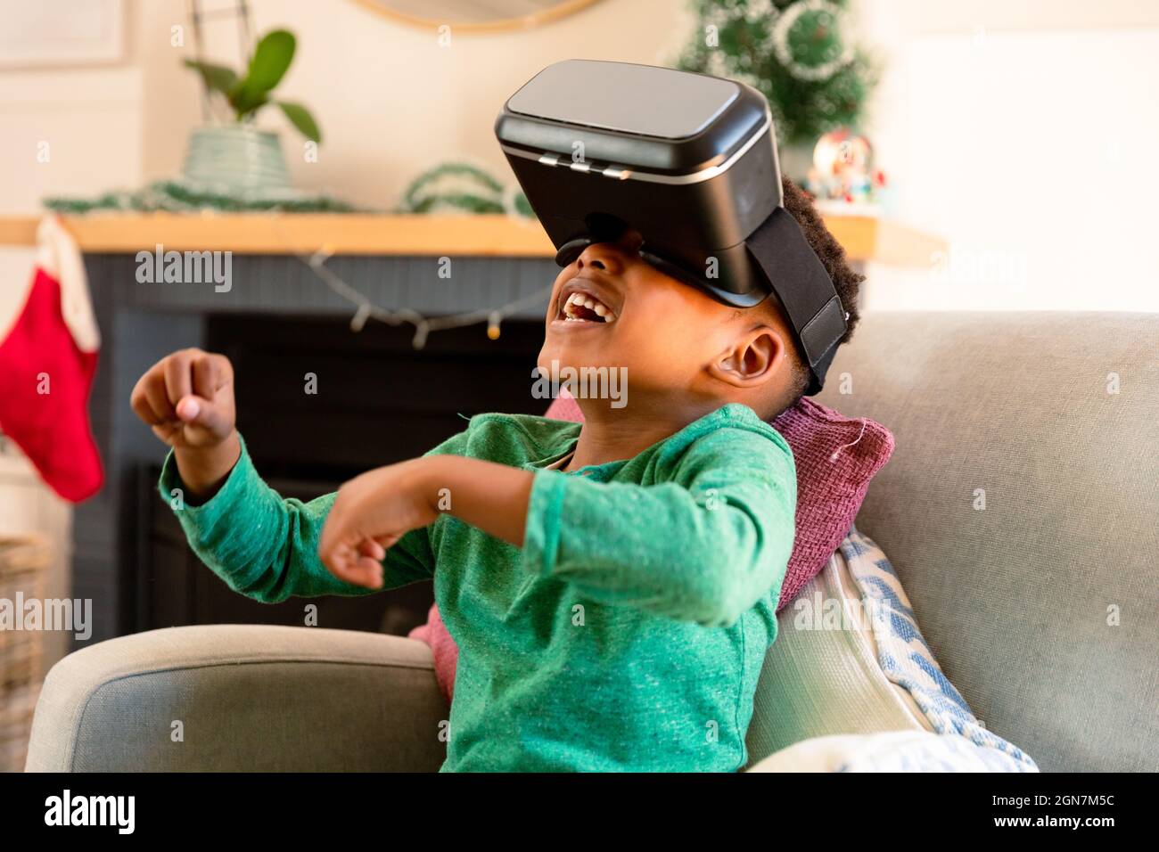 African american boy wearing vr headset and having fun at home Stock Photo