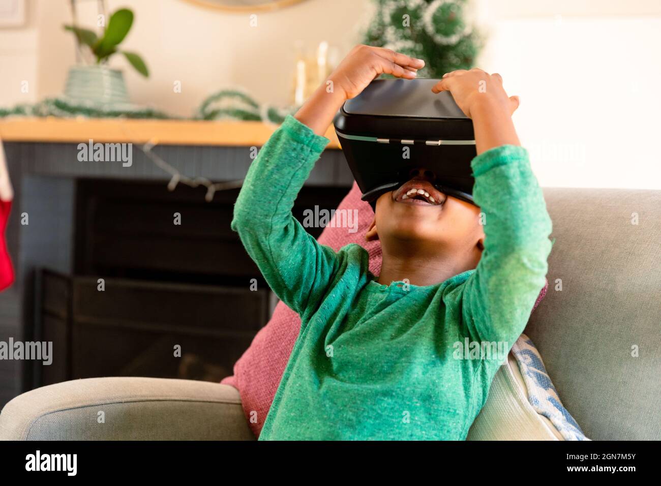 African american boy wearing vr headset and having fun at home Stock Photo