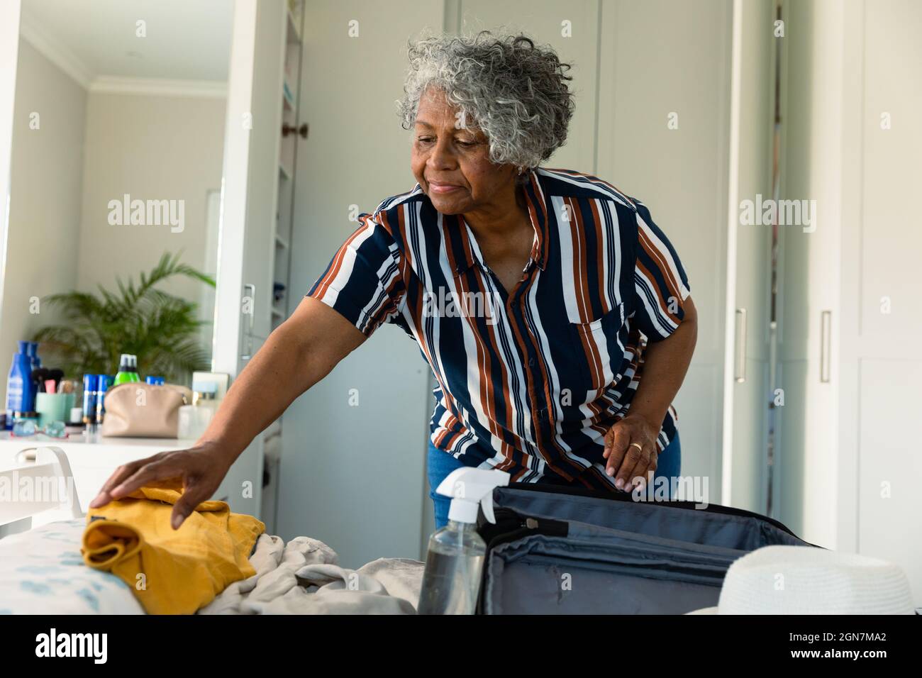 Calm woman packing luggage in bedroom · Free Stock Photo