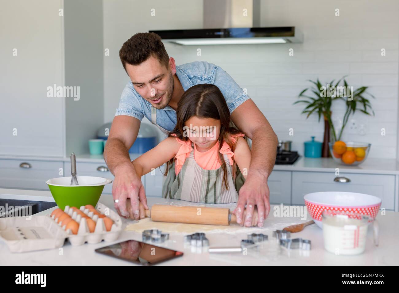 Happy caucasian father and daughter baking together, making cookies in ...