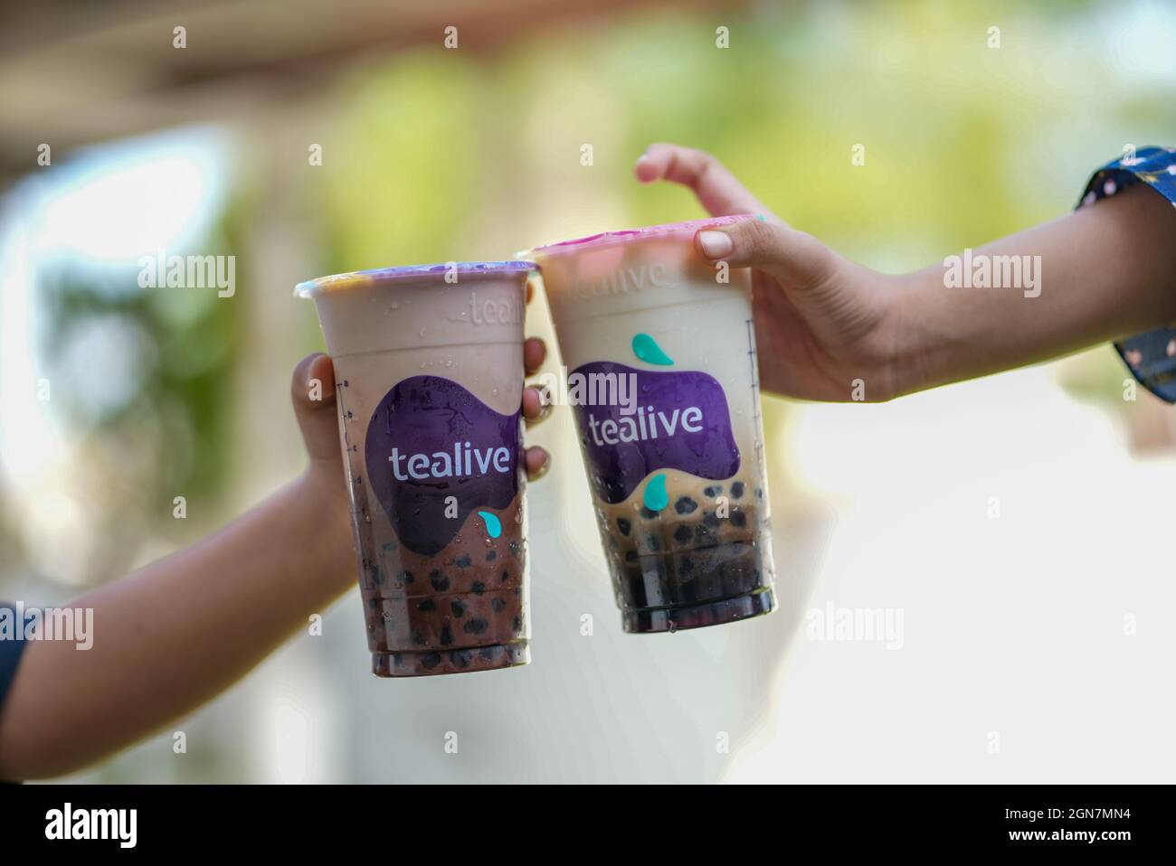 Kuala Lumpur, Malaysia - 23rd August 2021 : Hands holding a cup of Tealive drink. Tealive is a popular beverage company having more 600 outlets throug Stock Photo