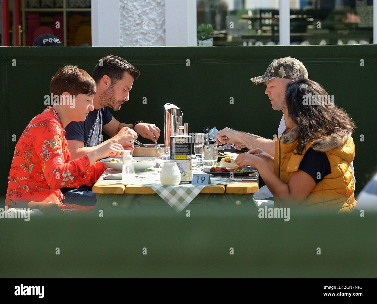 Young adults dining outdoors in the Craft village in Derry, Northern Ireland 2021. ©George Sweeney / Alamy Stock Photo Stock Photo