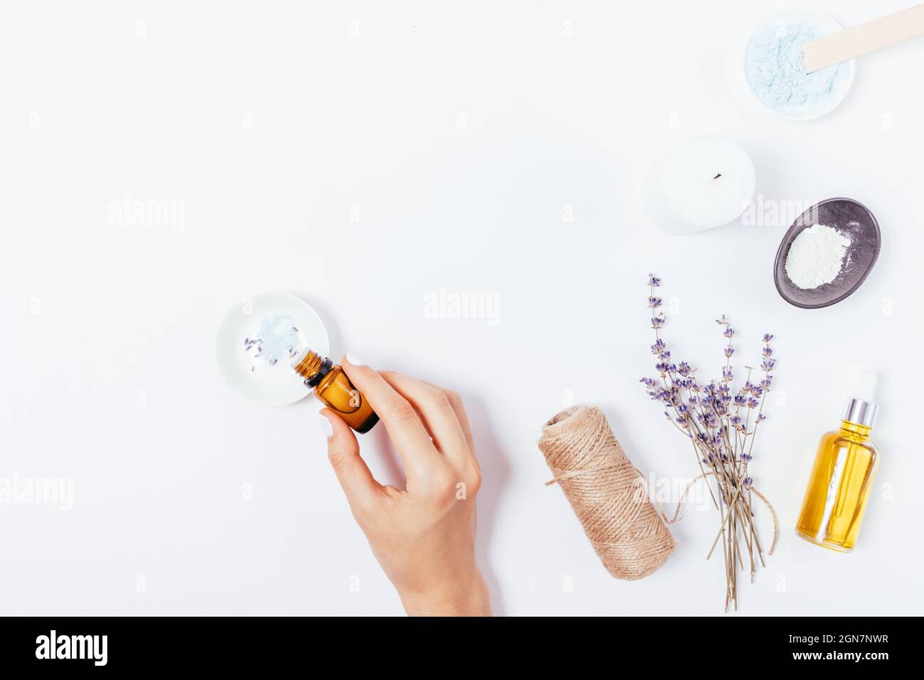 Woman hands mix homemade cosmetics adding essential oil next to ...