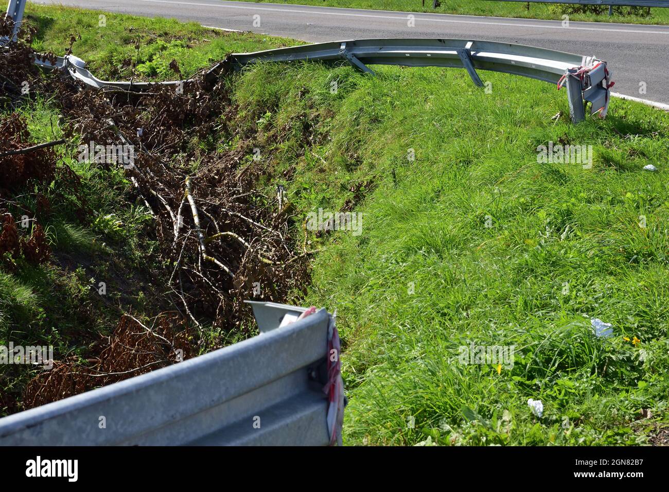 Damaged energy-consuming barrier by the road during an accident. Danger. Stock Photo
