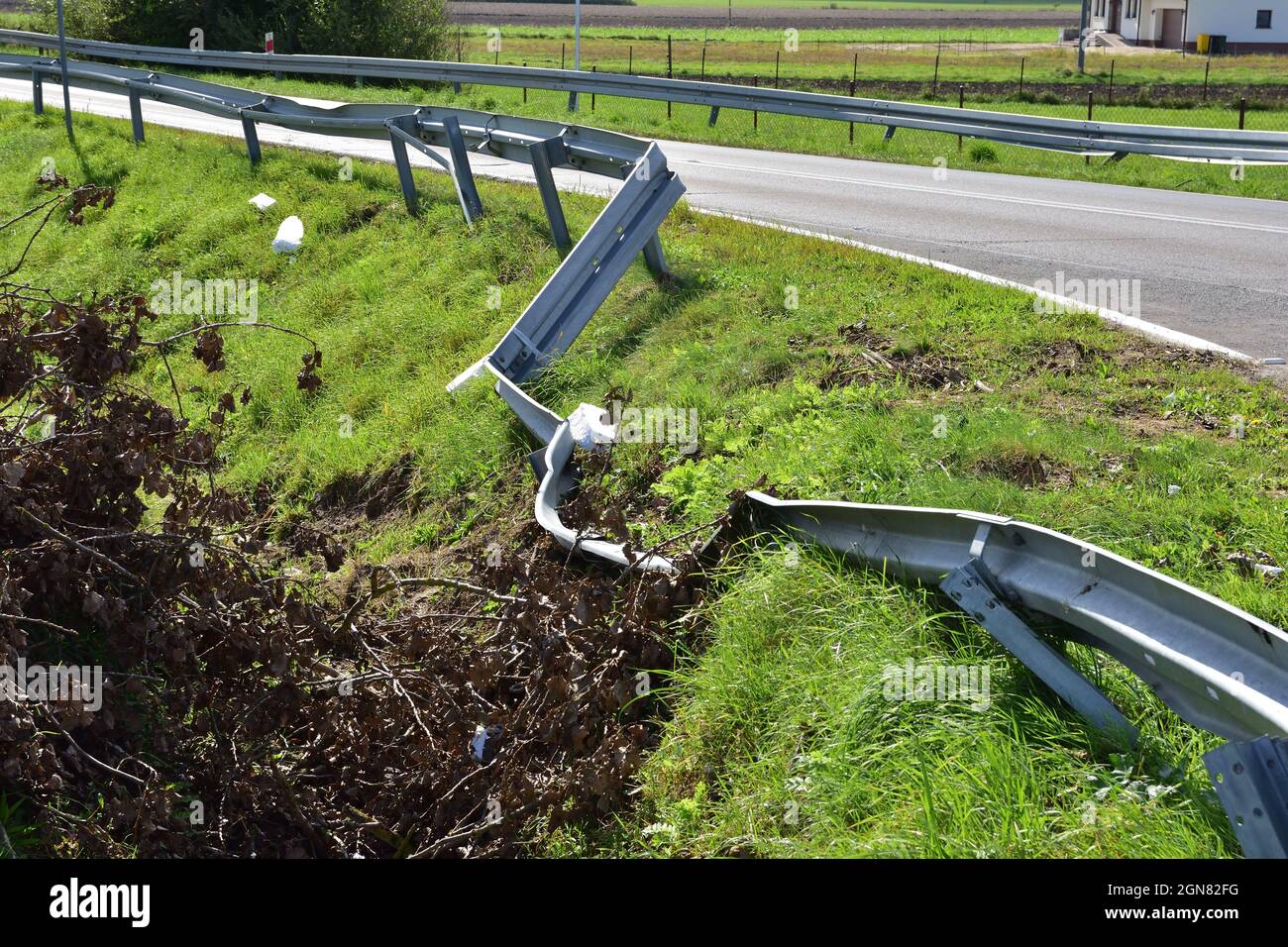 Damaged energy-consuming barrier by the road during an accident. Danger. Stock Photo
