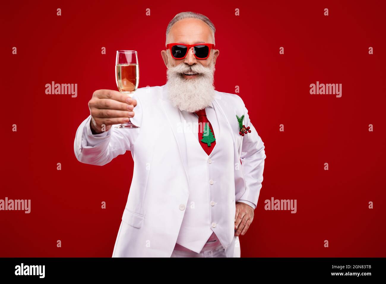 Photo of happy cheerful old man hold hands champagne glass make toast entertainer isolated on red color background Stock Photo