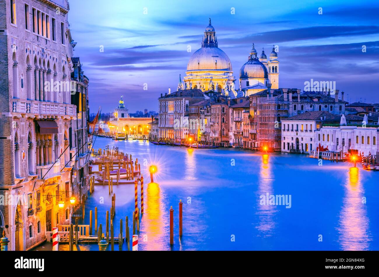 Venice, Italy. Colored sunset twilight on Grand Canal and Basilica Santa Maria della Salute, italian famous Venezia. Stock Photo