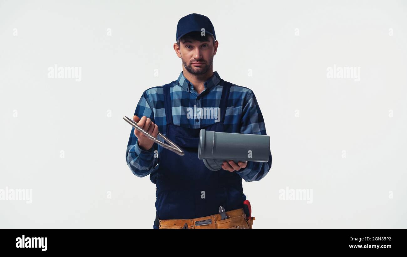 Plumber in overalls and cap holding pipes isolated on white Stock Photo Alamy