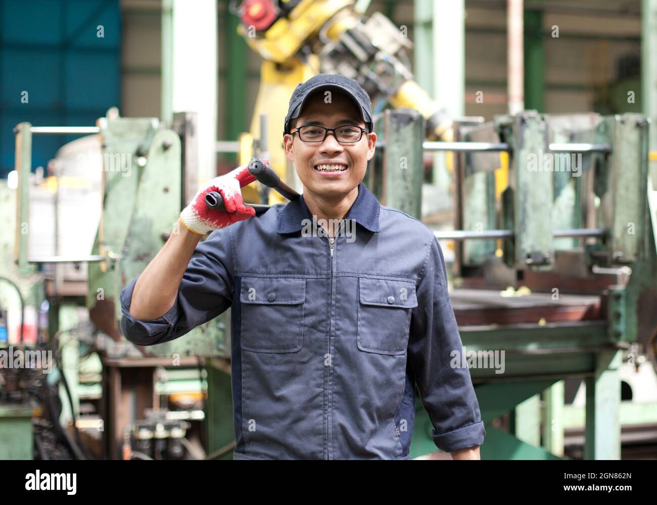 Engineer holding tool work with robot machine in background Stock Photo ...