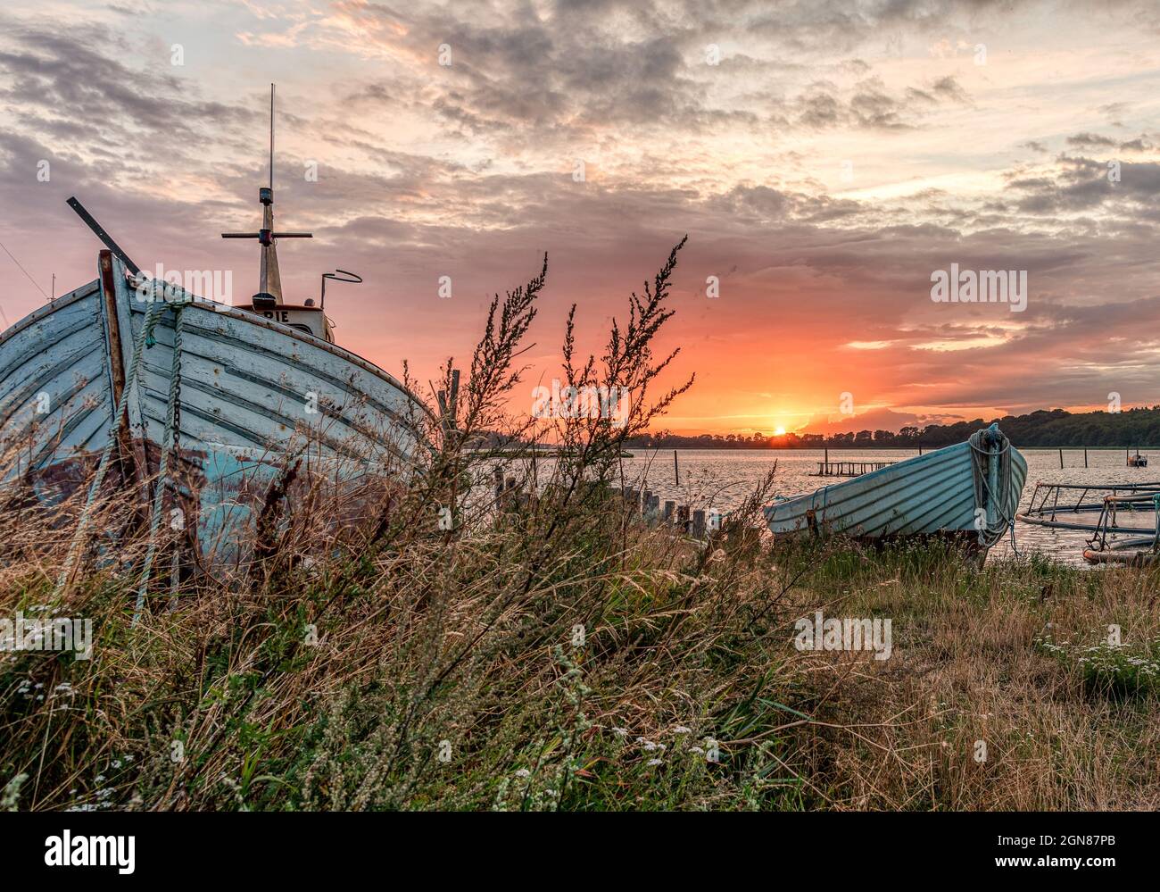 Old wooden boat on beach sunset hi-res stock photography and images - Alamy