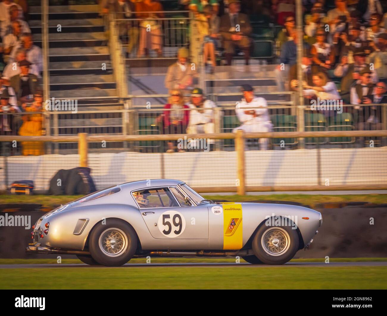 Ferrari 250 GT SWB racing at sunset at the Goodwood Revival 2021, West Sussex, uk Stock Photo
