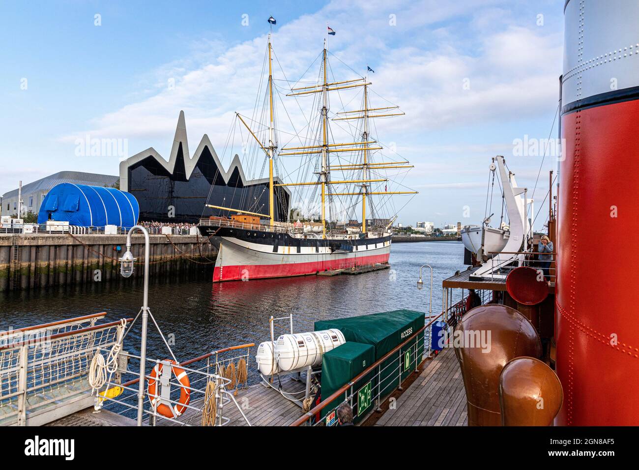 Tall ship Glenlee beside the Riverside Museum of Transport on the banks of the River Clyde viewed from the paddlesteamer Waverley, Glasgow, Scotland. Stock Photo