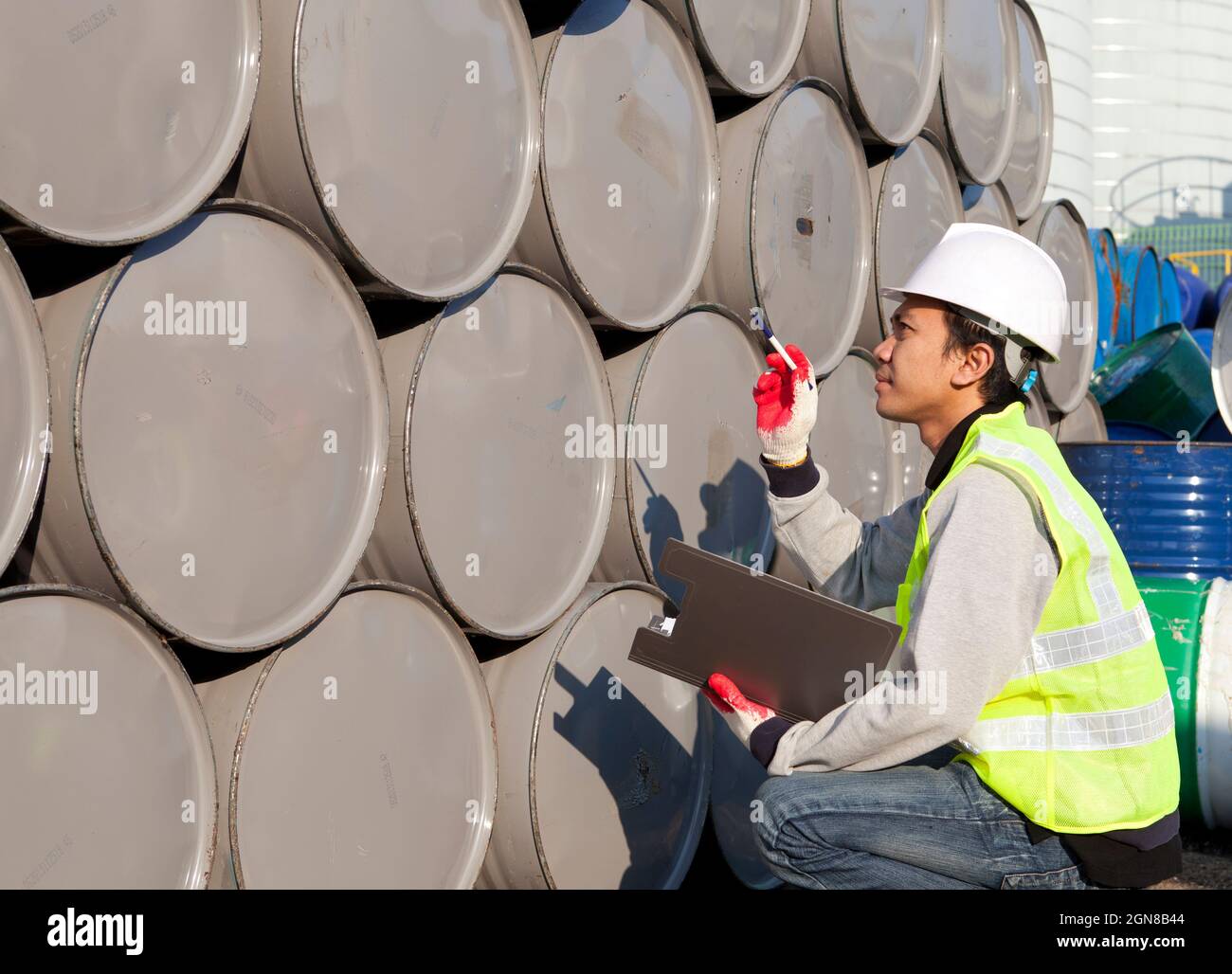 Factory worker calculate of drums Stock Photo - Alamy