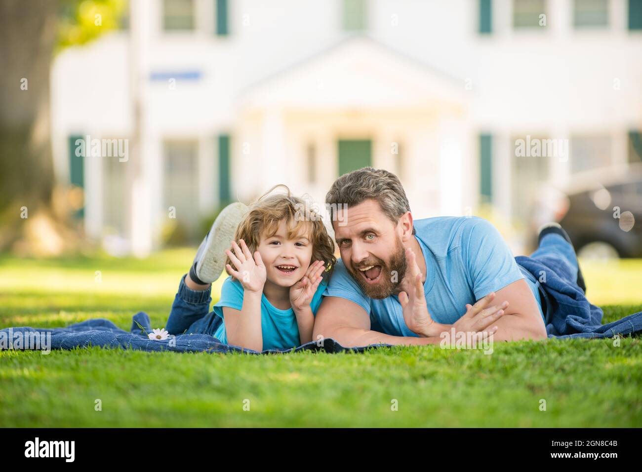 family value. childhood and parenthood. parent relax with little child boy on grass. Stock Photo