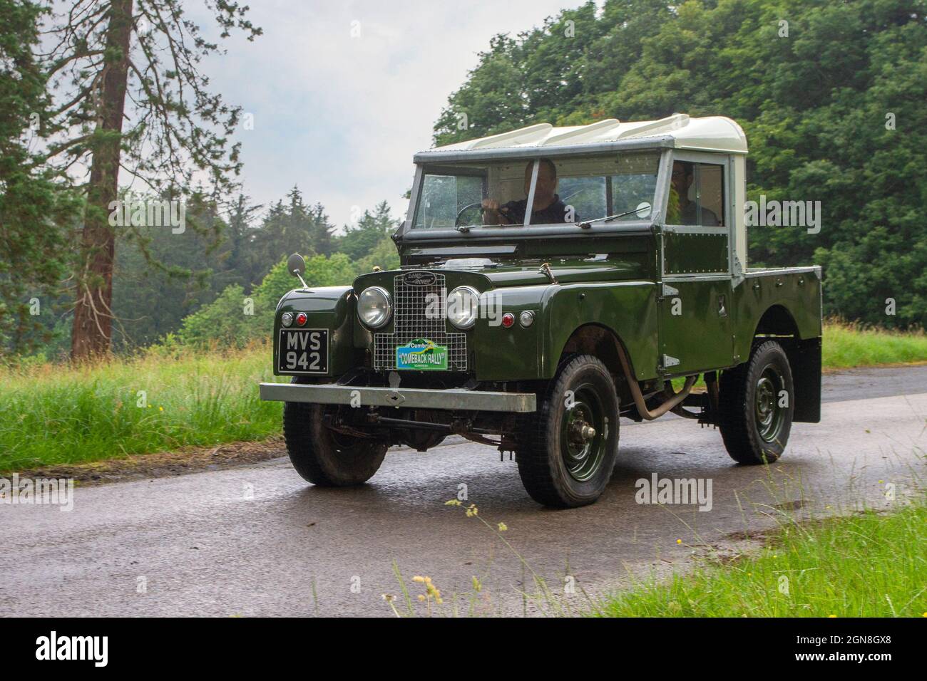 1957 50s green Land Rover en-route KLMC at ‘The Cars the Star Show” in Holker Hall & Gardens, Grange-over-Sands, UK Stock Photo