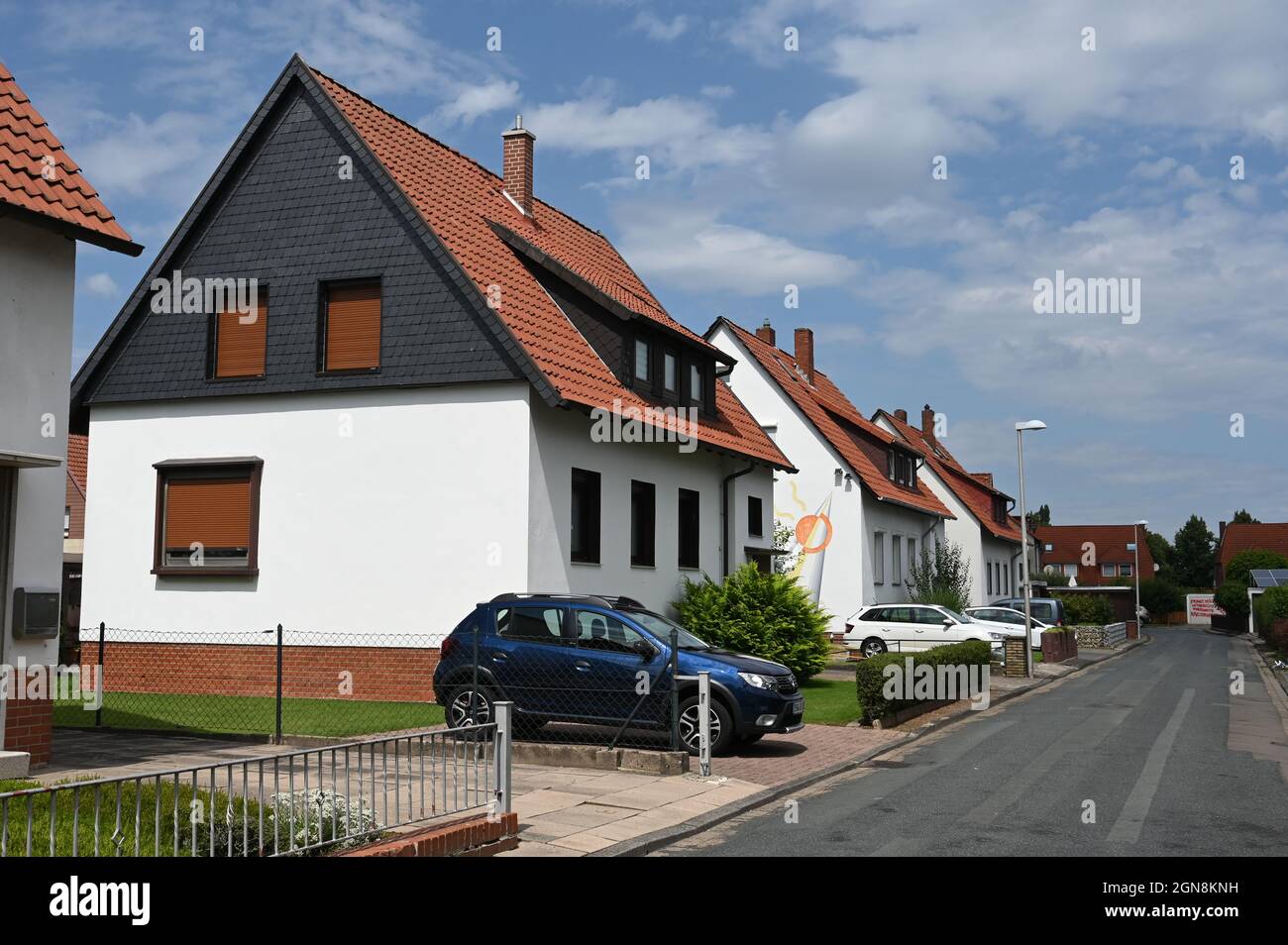 Small houses of the German post-war period with cars in the driveway Stock Photo