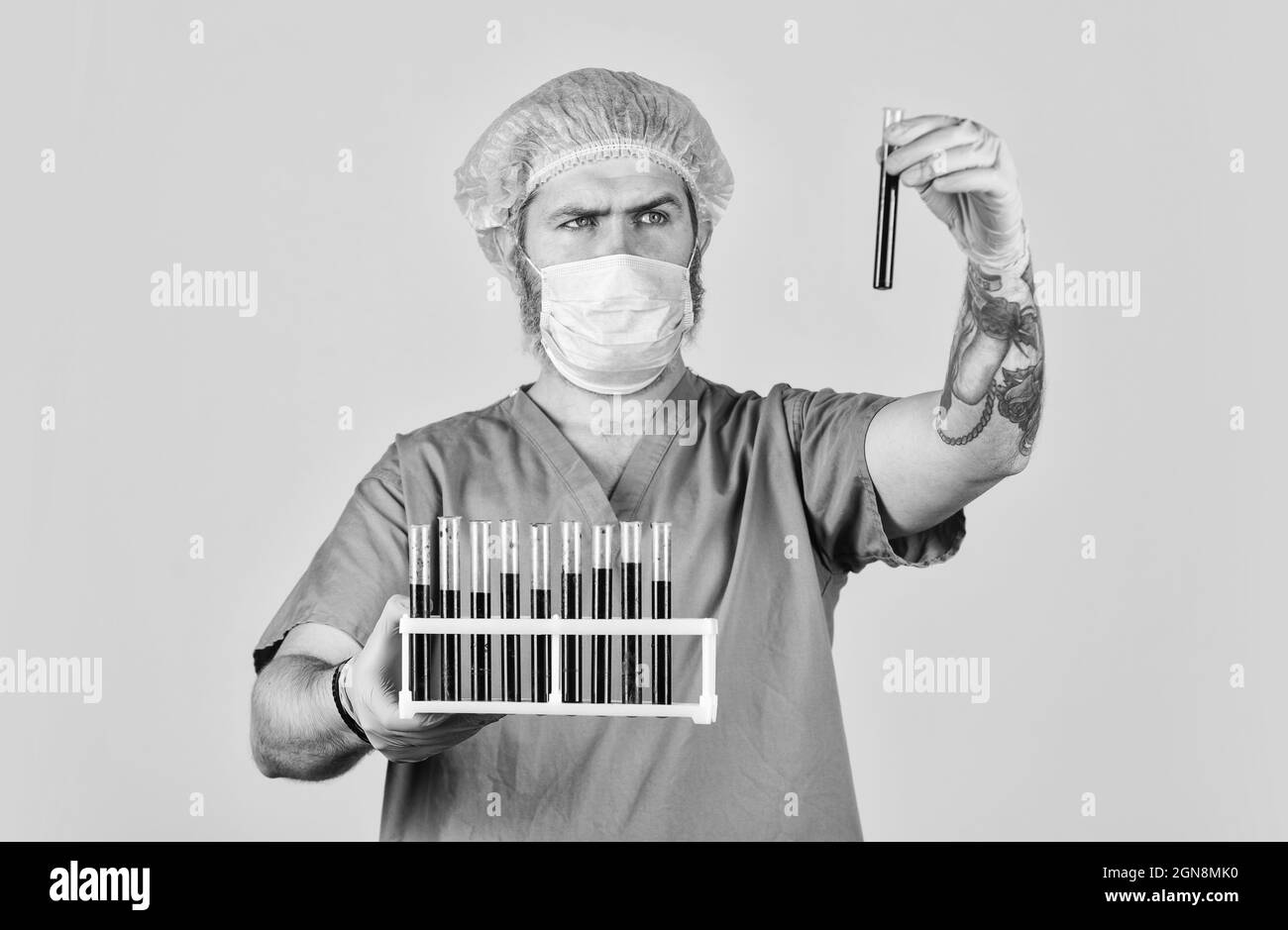 Epidemic threshold. Critical number or density of susceptible hosts. Man in medical lab inspecting samples biological material. Epidemic disease Stock Photo