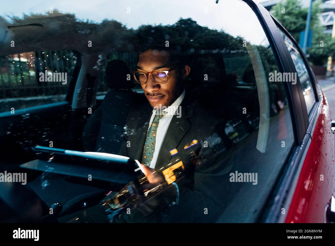 Young businessman using digital tablet while sitting in car Stock Photo