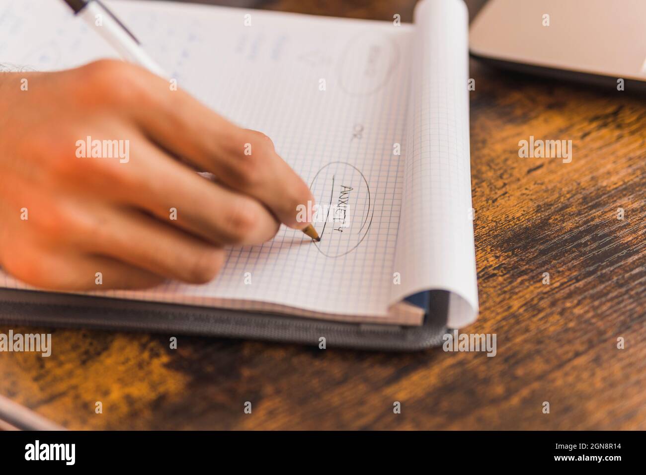 Male psychologist writing in note pad while working at office Stock Photo