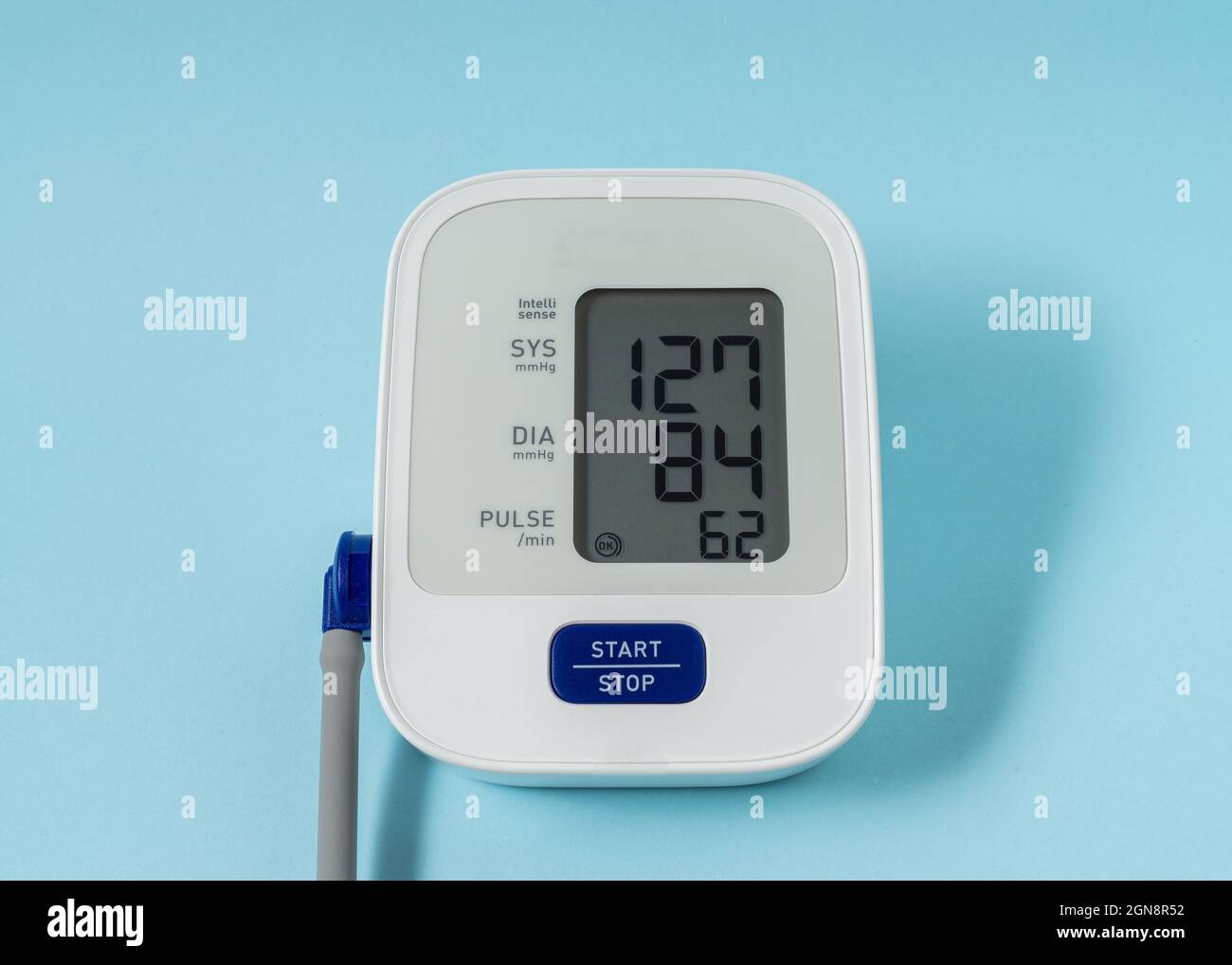 Blood pressure monitor on light blue background Stock Photo - Alamy