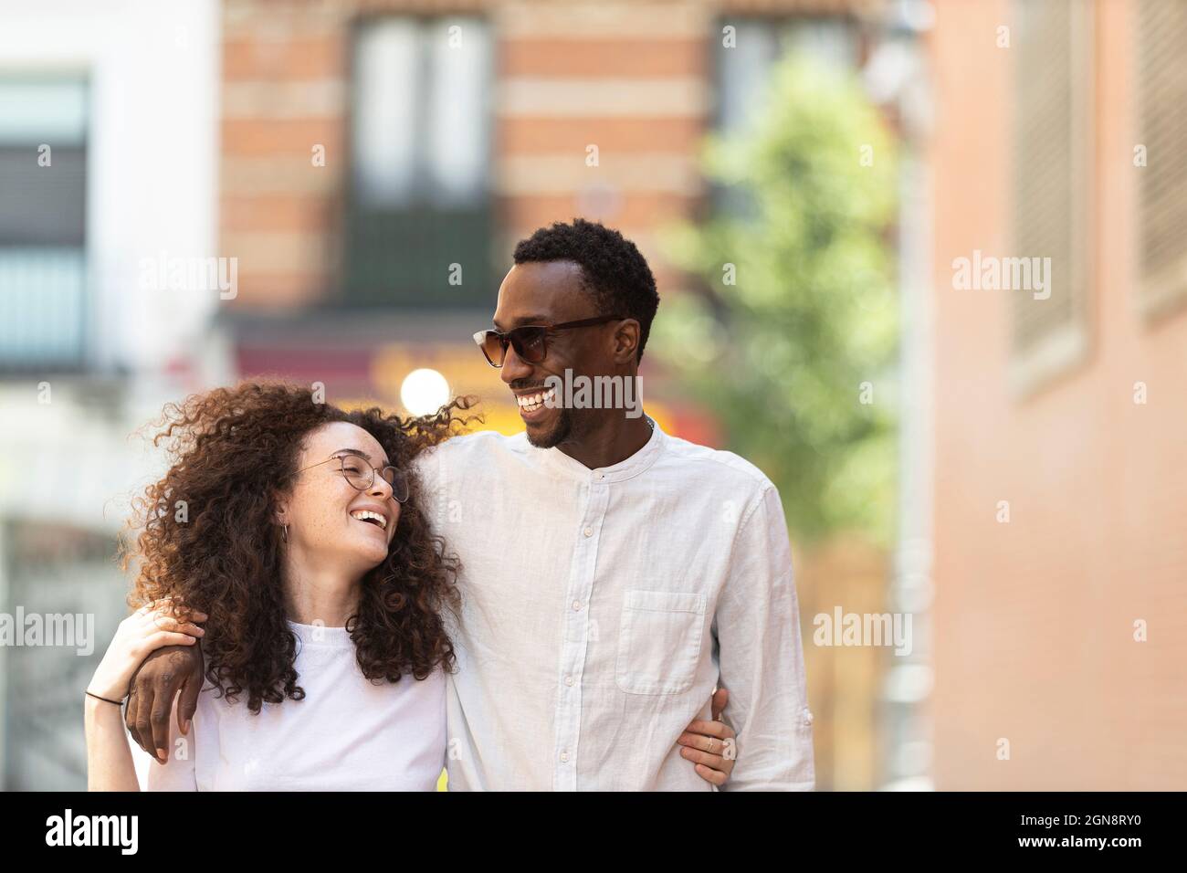 Man with arms around woman hi-res stock photography and images - Alamy