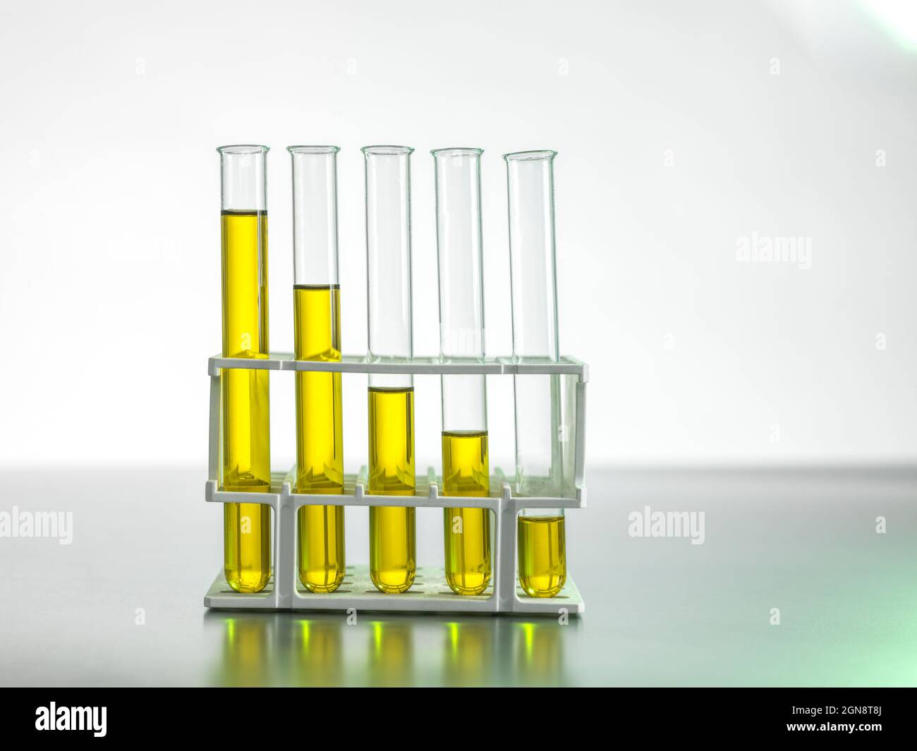 Oil in test tubes on table Stock Photo