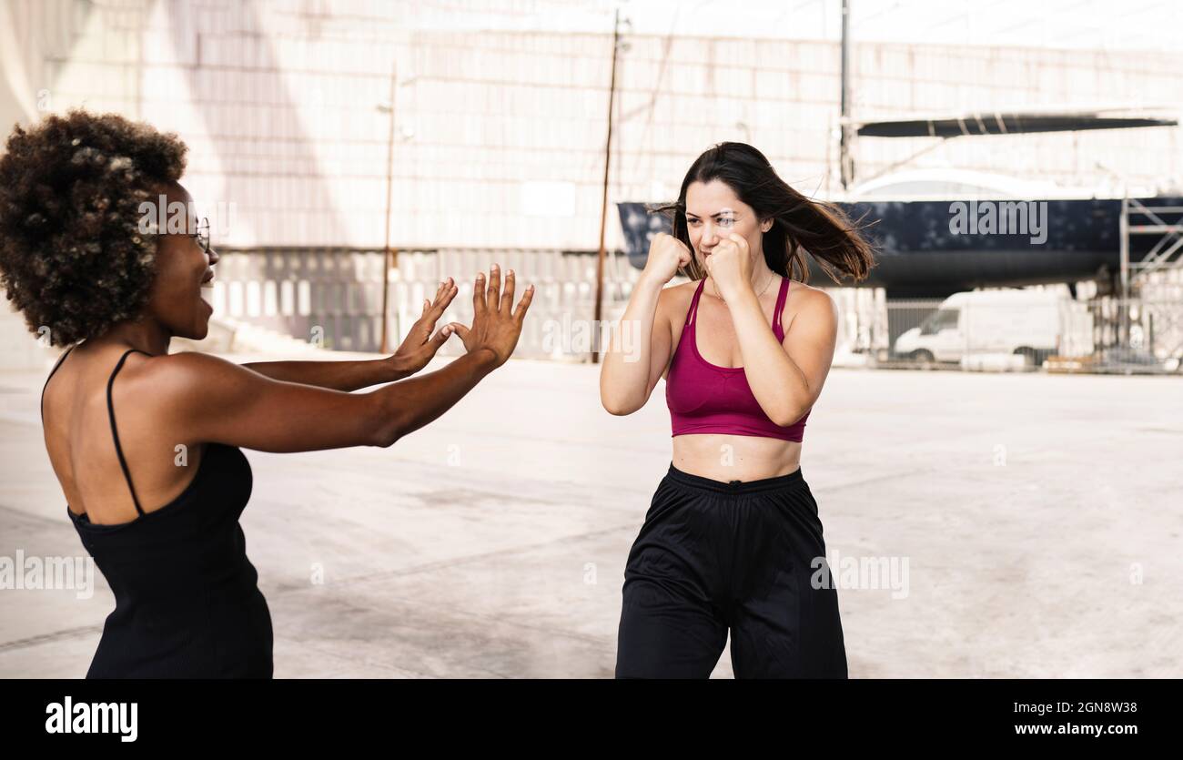 Mid adult female practicing sports with friend Stock Photo