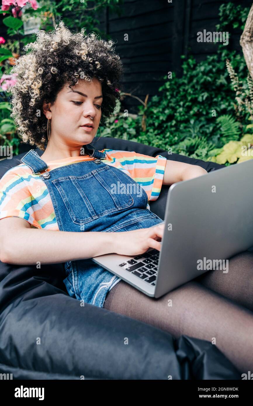 Woman sitting on bean bag hi-res stock photography and images - Alamy