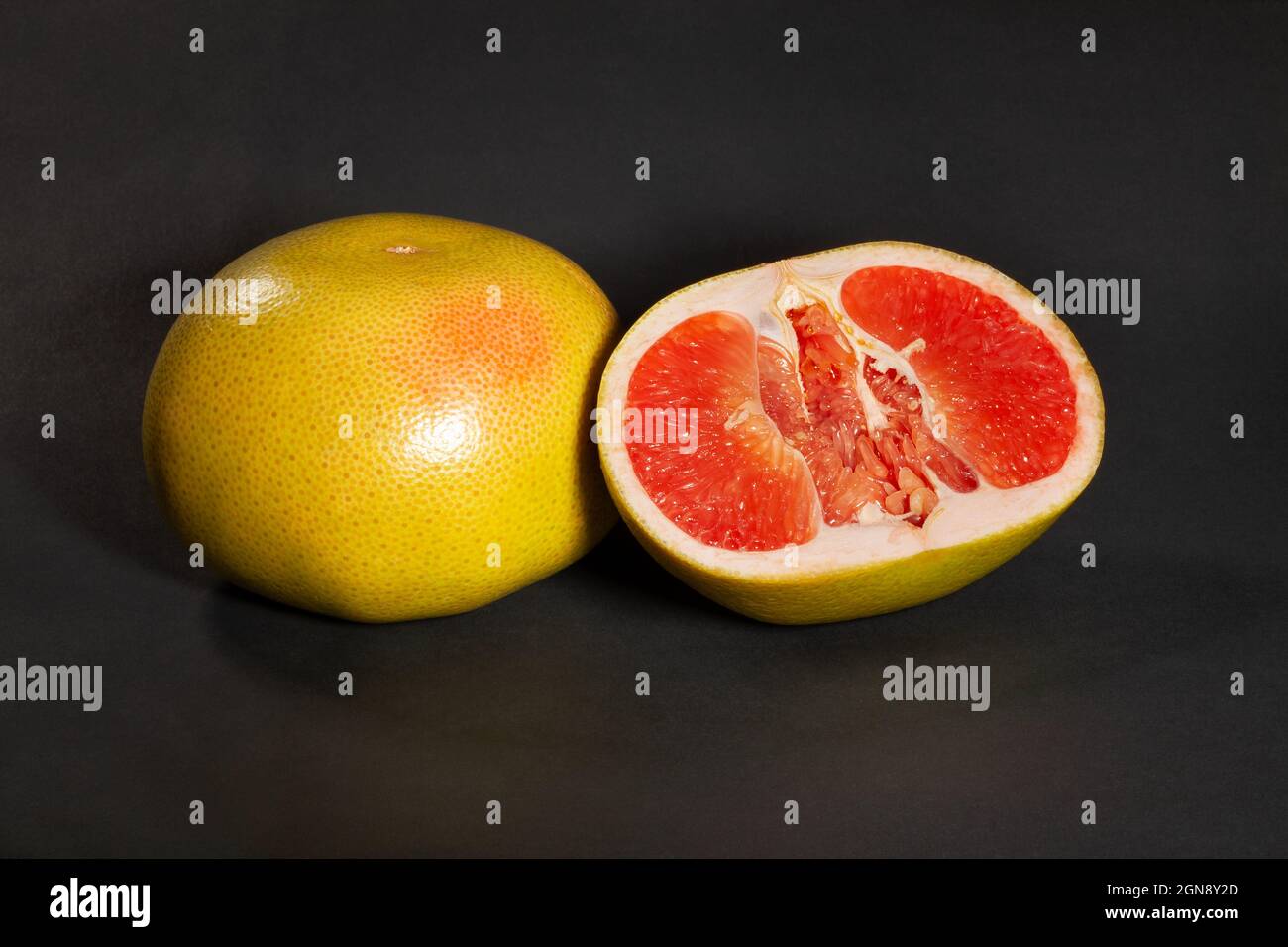sliced yellow grapefruit on black background Stock Photo