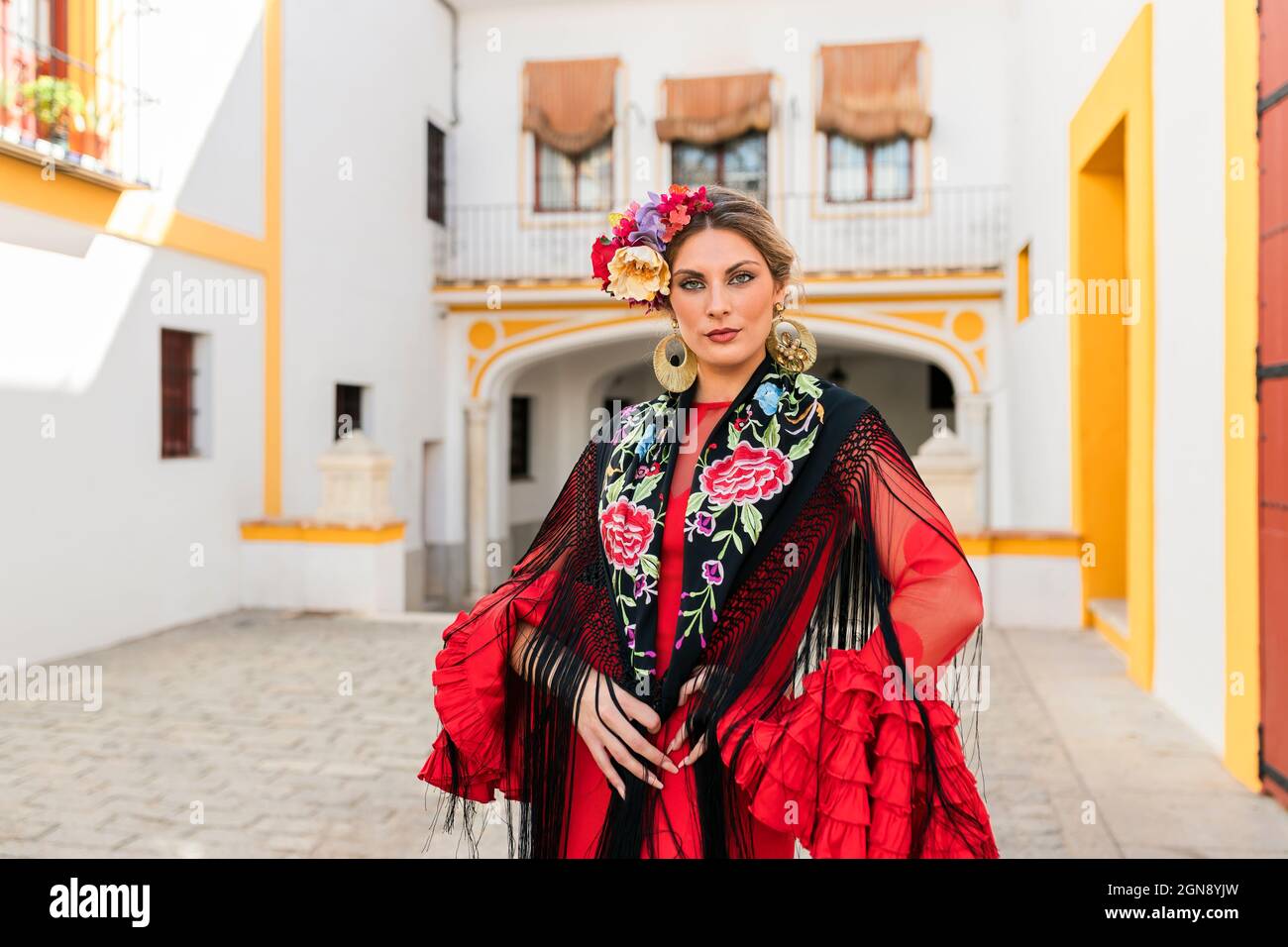 Woman in traditional dress standing at Plaza de toros de la Real Maestranza de Caballeria de Sevilla, Spain Stock Photo